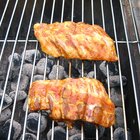 BBQ Roast Baby Back Pork Ribs Close-up On Hot Grill