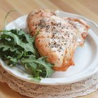 Raw chicken leg on cutting board on wooden background