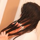 low angle view of a mother putting curlers in her daughter's hair