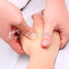 a caucasian woman massages the neck of a relaxed client