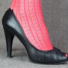 Young woman trying on shoes, low section, side view