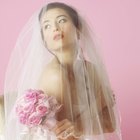 Woman in wedding gown looking out window of church