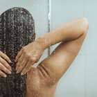 Side profile of mother and her daughter washing the bathtub