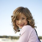 Smiling woman combing her hair