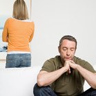 Photo of couple in decorated garland lights room guy giving lady unexpected engage ring box waiting answer sitting cozy near x-mas tree indoors wear red sweaters