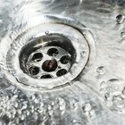 Woman washing long hair in shower under water jet
