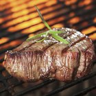 Butcher cutting beef meat on a wooden table
