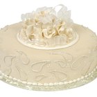 Bride and groom figurines standing on two separated slices of wedding cake