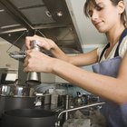 Woman Holding a Bowl and a Wooden Spoon in a Kitchen
