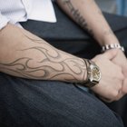 Tattooer concentrating on giving someone a tattoo