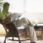 Businessman holding coffee cup, laptop on desk