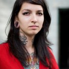 Tattooer concentrating on giving someone a tattoo