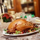 Couple basting thanksgiving turkey