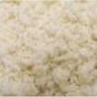 Boiled white rice in ceramic pot on wooden background.
