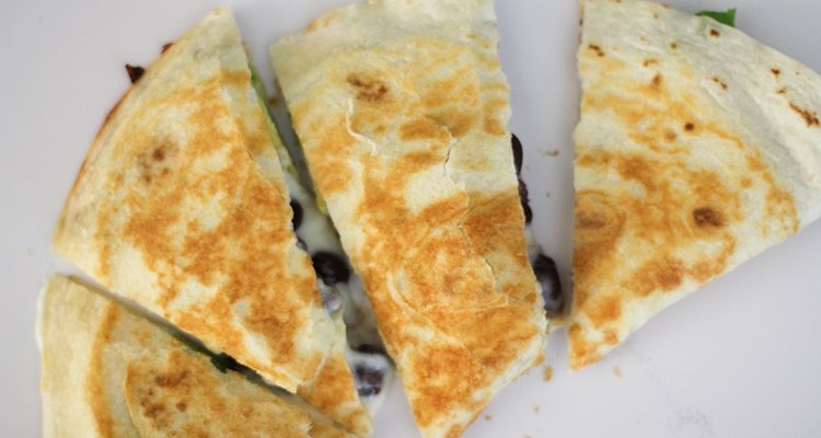Cooked quesadilla cut into four pieces.