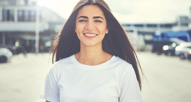 A young woman smiles at the camera.