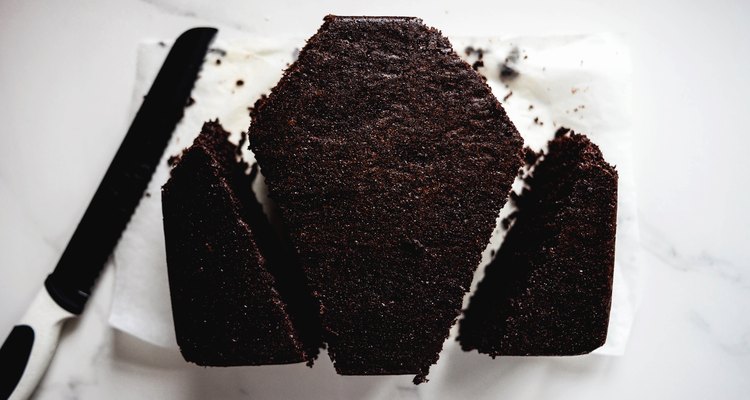 Trim the cake to form a coffin shape.