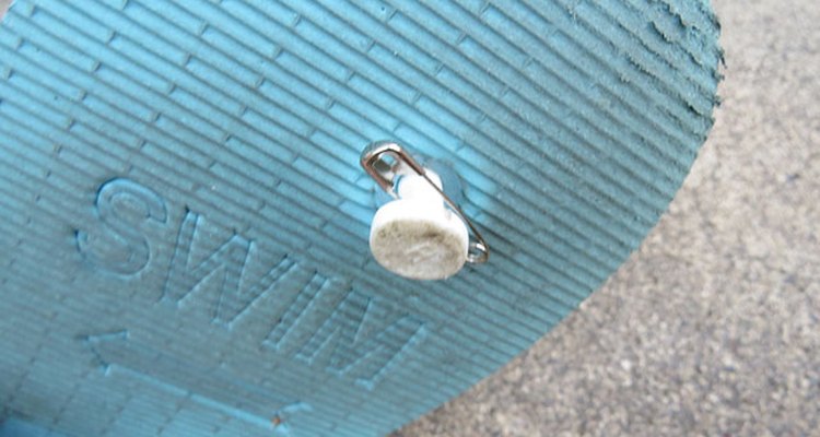 Attach safety pin to rubber stud.