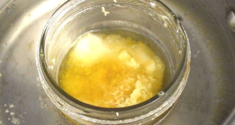 Make a double boiler with a jar and stainless steel pot.