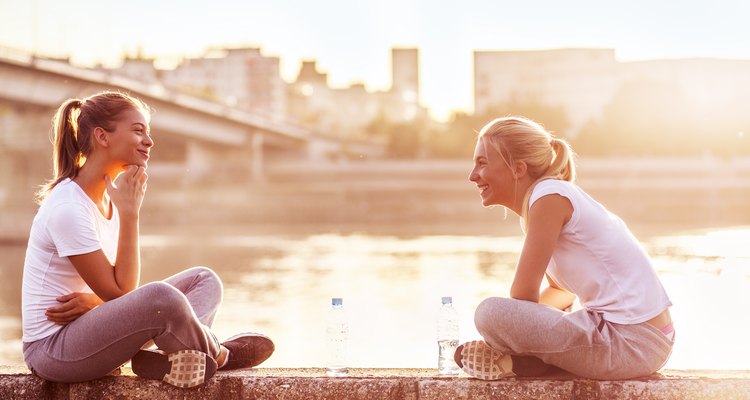 Two young women relax after a workout.
