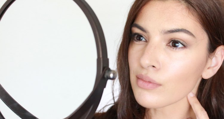 Checking skin in mirror