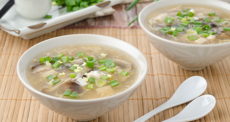 Chinese spicy soup with egg, shiitake mushrooms, tofu and green