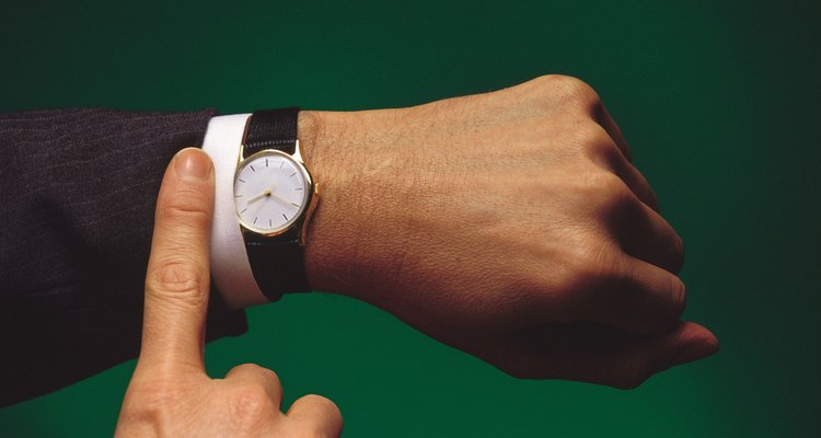 Man pointing at wristwatch
