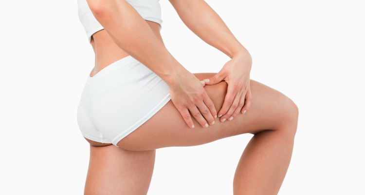 Fit woman touching her thigh