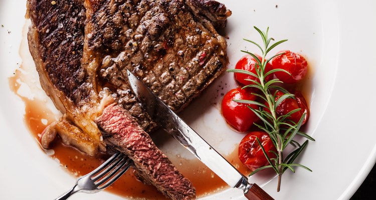 Sliced grilled steak Ribeye with grilled cherry tomatoes