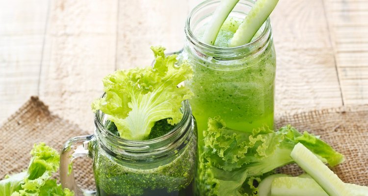 smoothie detox lettuce and cucumber on sack and wooden background