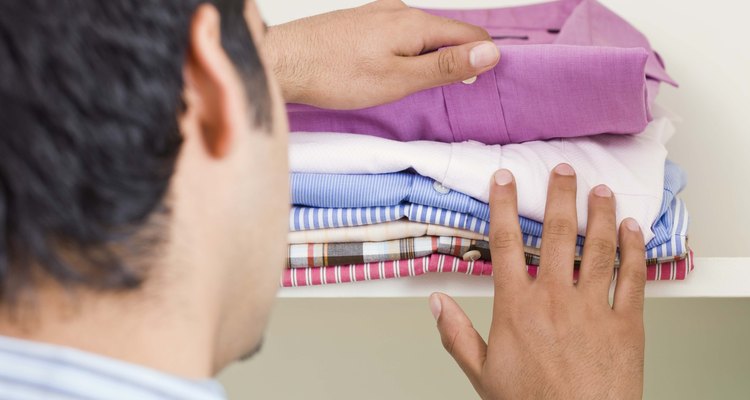 Man with folded shirts
