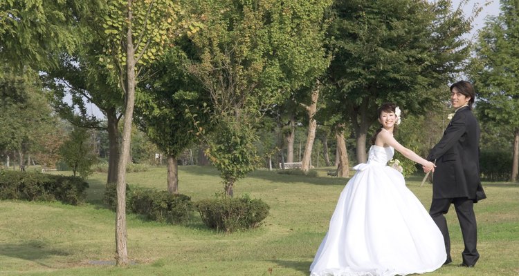 Bride and groom holding hands outdoors