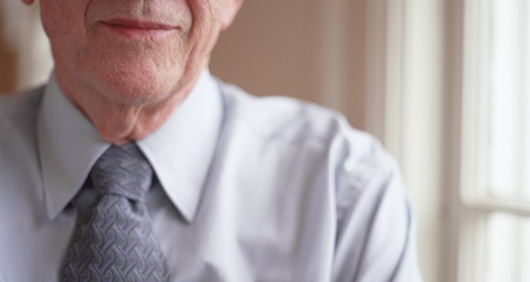 Senior man wearing shirt and tie and spectacles, posing indoors, close-up, portrait