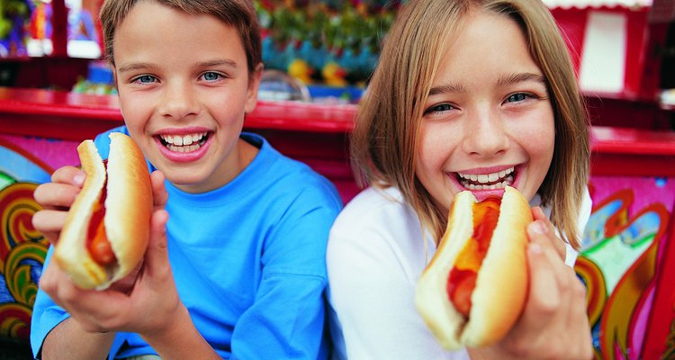 Portrait of a Brother and Sister Holding Hot Dogs