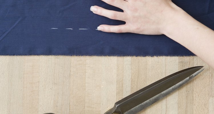 Hands measuring fabric