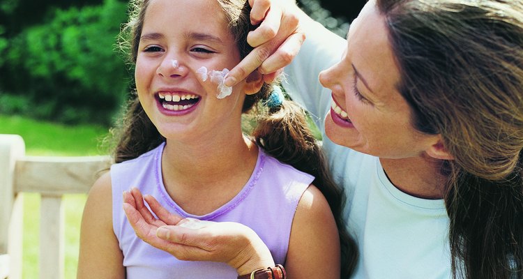 Mother Applying Suntan Lotion to her Daughter