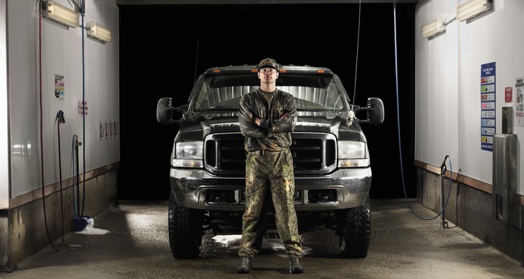 Man dressed in camouflage in front of truck