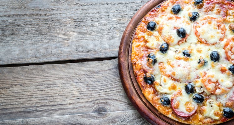 Cooked pizza on the wooden board