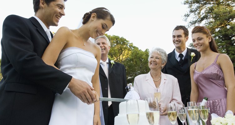 Bride and groom cutting cake