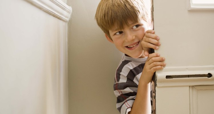 Boy peering around door