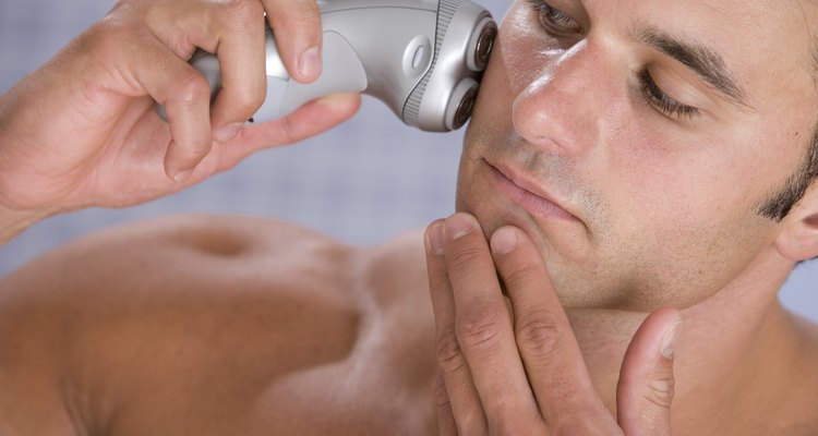 Man shaving with electric razor