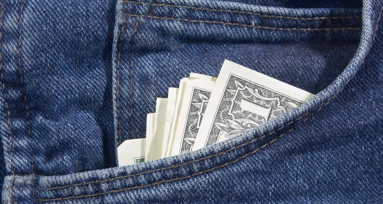 Dollar bills in pocket of jeans