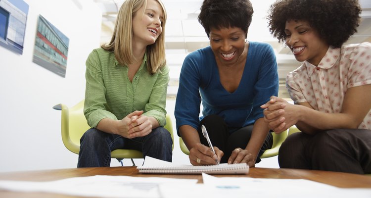 Co-Workers Writing on Paper