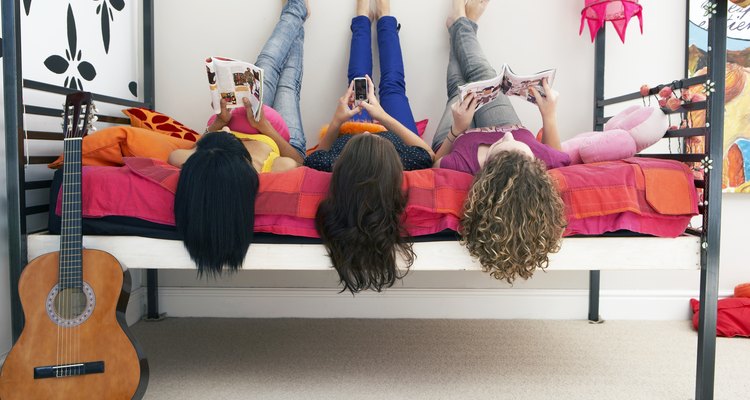 three girls lying on bed