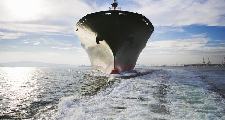 Bow view of cargo ship sailing out of port.