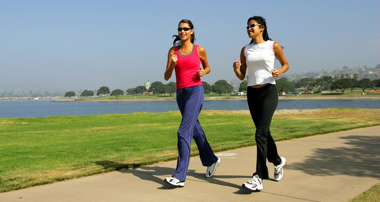 Two women jogging on the seafront.