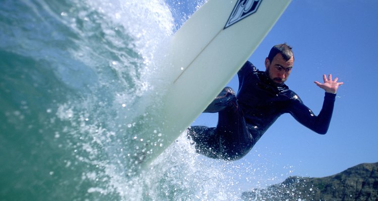 Low angle view of a mid adult man surfing in the sea