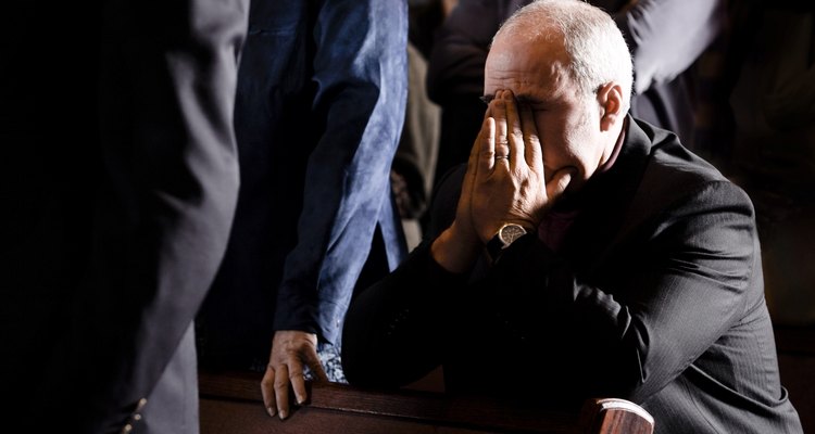 Man praying in a pew
