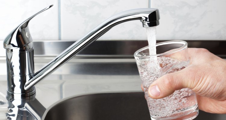 Glass filled with drinking water from kitchen faucet.