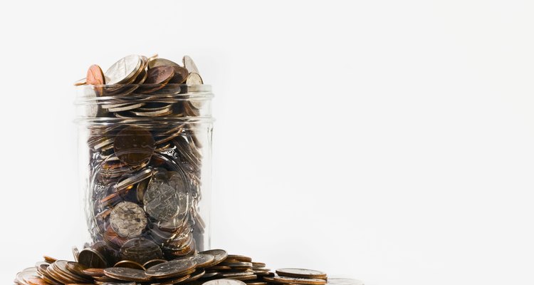 Canning jar overflowing with coins